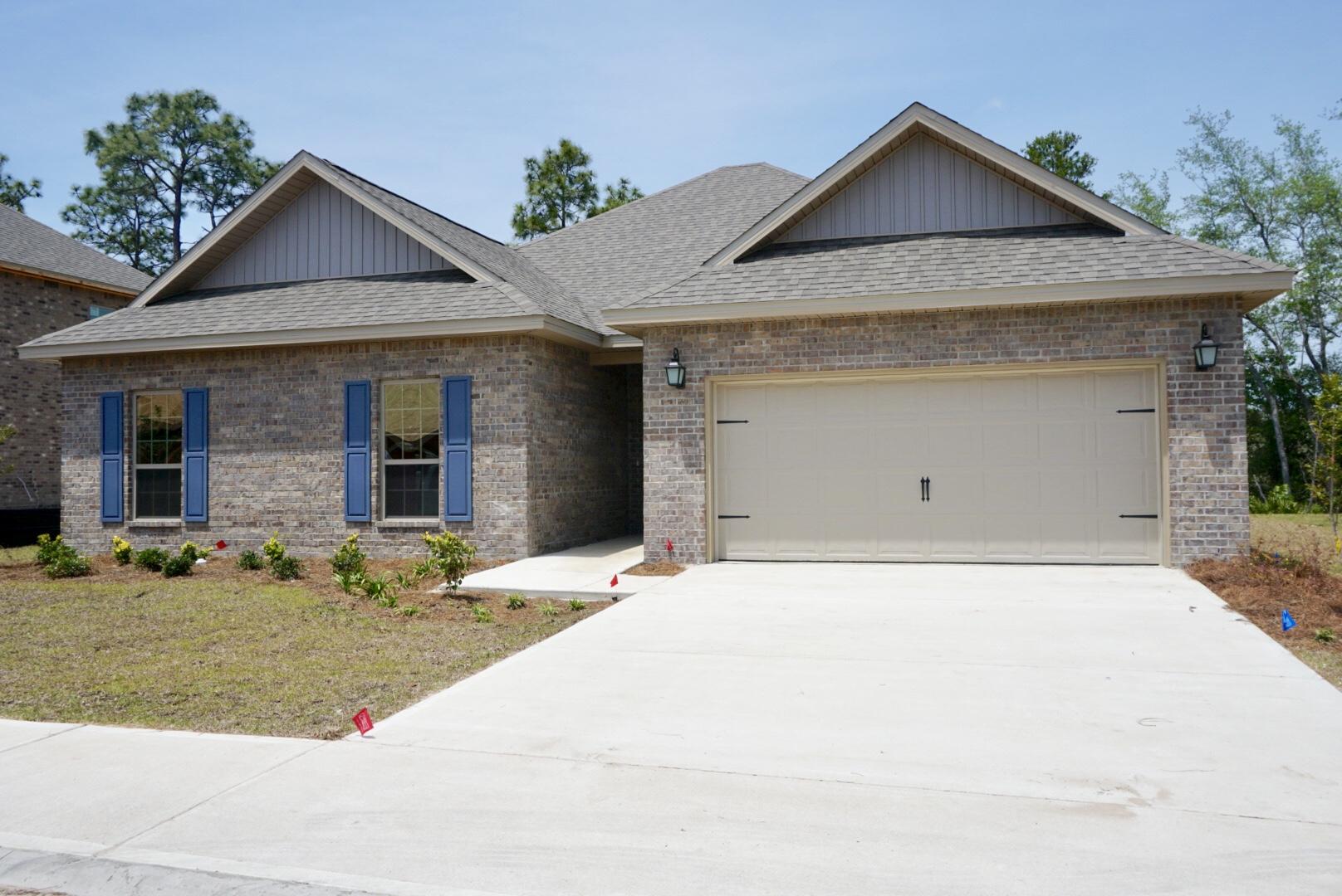 145 Wayne Trail Santa Rosa Beach, FL 32459 - Photo 1 of 15 a front view of a house with a yard and garage