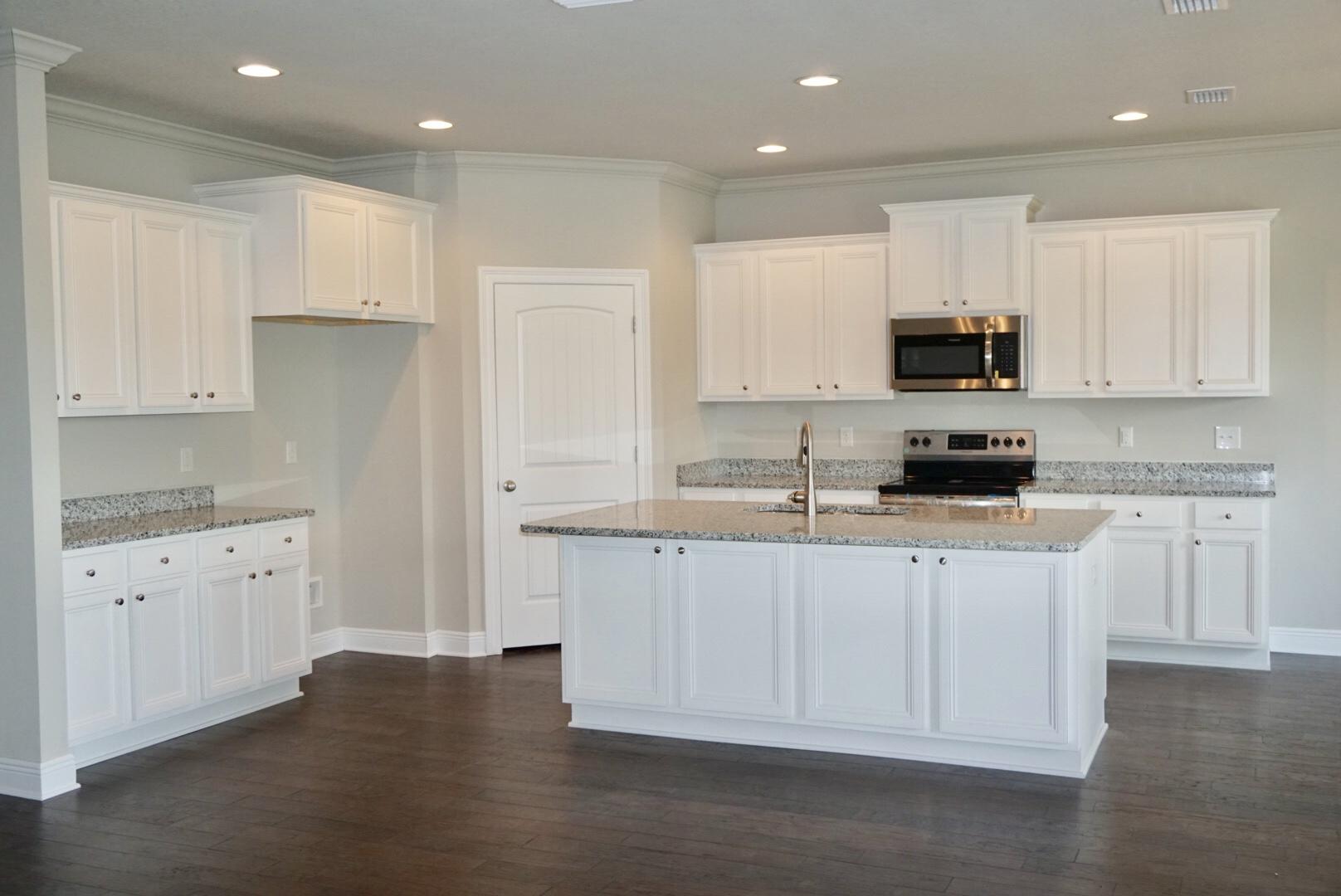 145 Wayne Trail Santa Rosa Beach, FL 32459 - Photo 5 of 15 a kitchen with granite countertop white cabinets white stainless steel appliances and sink