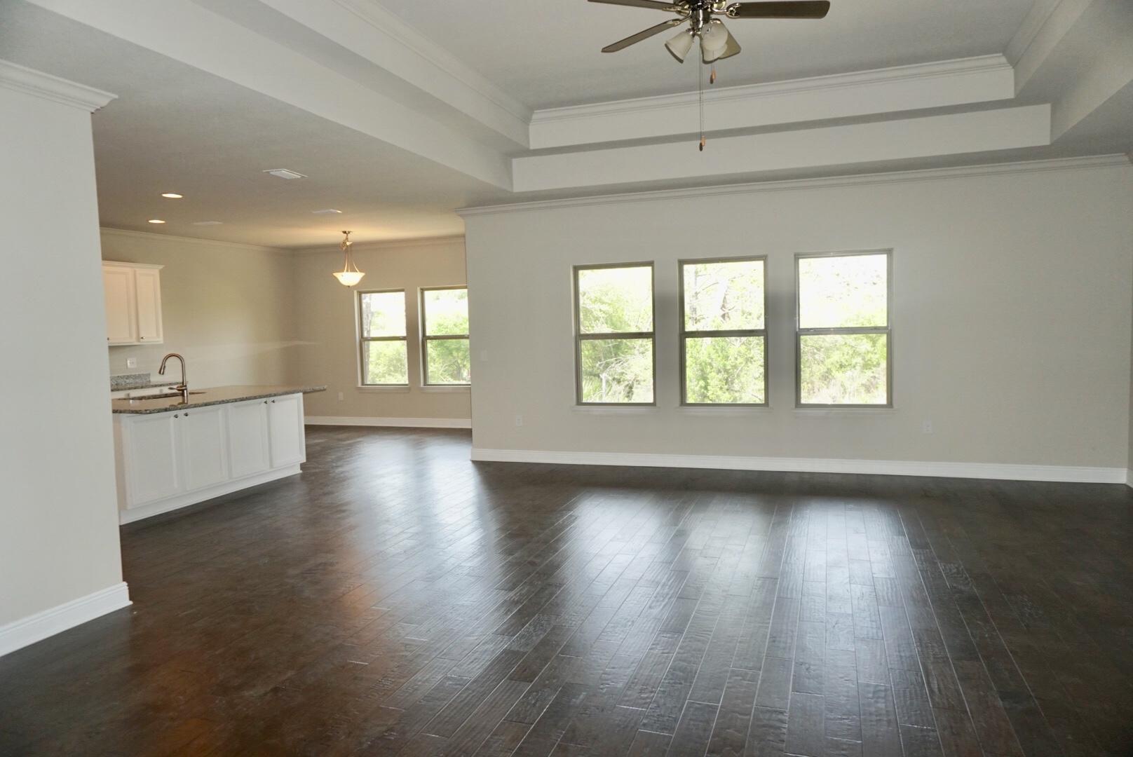 145 Wayne Trail Santa Rosa Beach, FL 32459 - Photo 6 of 15 a view of an empty room with a window and wooden floor