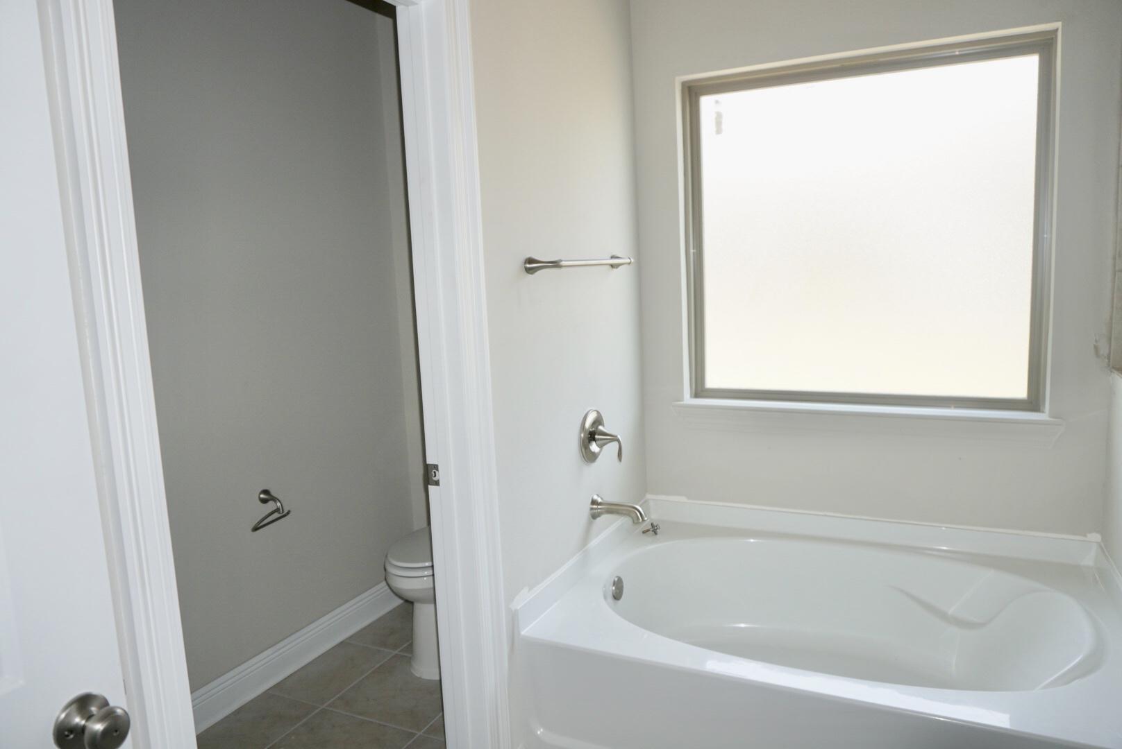 145 Wayne Trail Santa Rosa Beach, FL 32459 - Photo 8 of 15 a white bath tub sitting next to a window