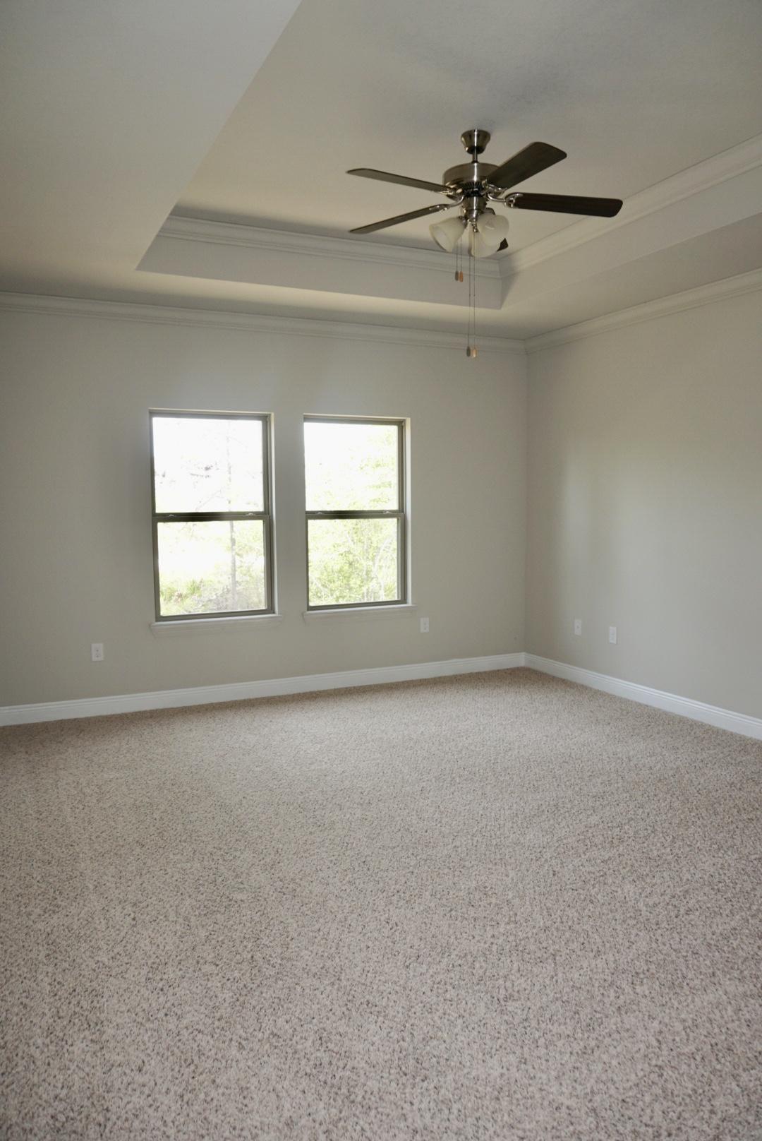 145 Wayne Trail Santa Rosa Beach, FL 32459 - Photo 9 of 15 an empty room with windows and fan