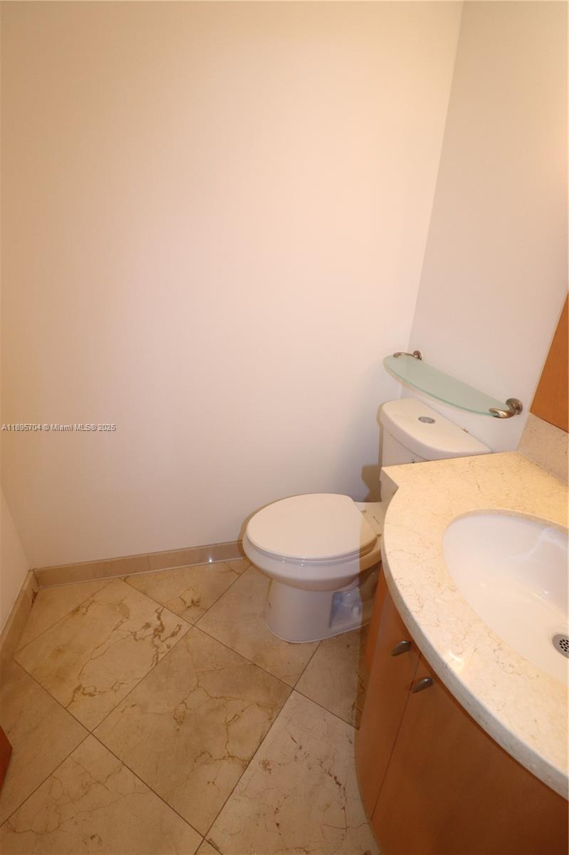 201 Crandon Boulevard, Unit 636 Key Biscayne, FL 33149 - Photo 13 of 53 a white toilet sitting next to a white sink