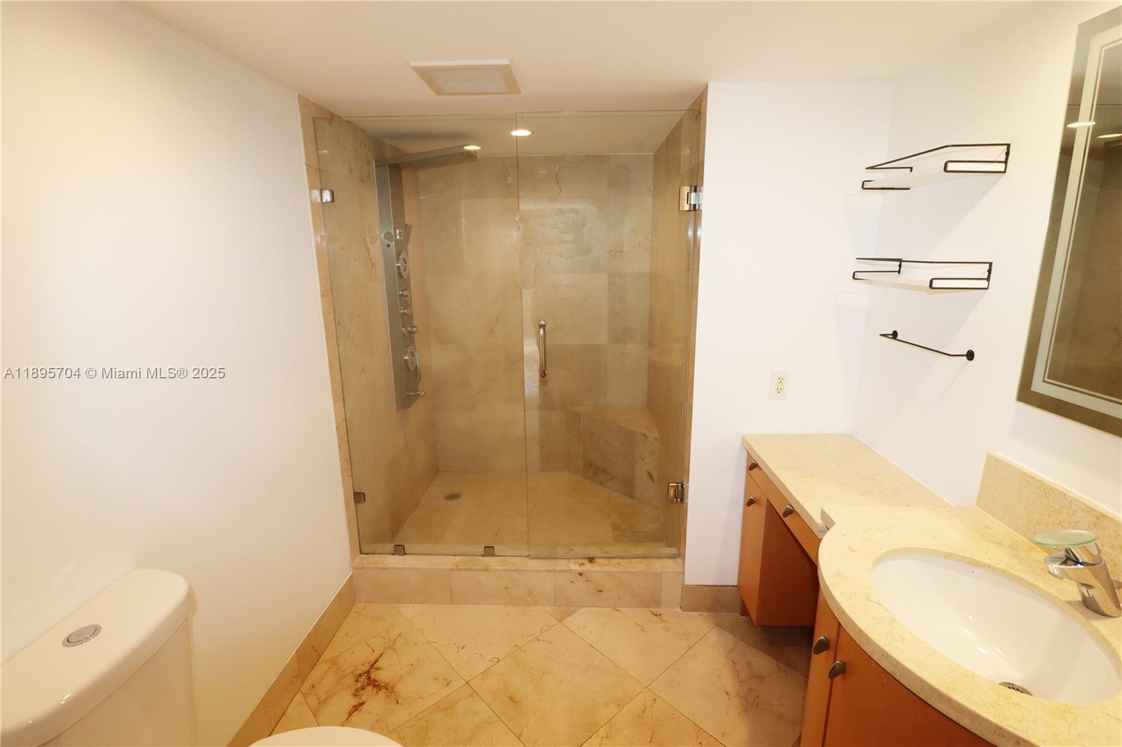 201 Crandon Boulevard, Unit 636 Key Biscayne, FL 33149 - Photo 25 of 53 a bathroom with a tub sink and a mirror