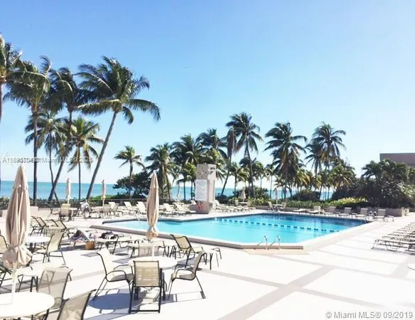a view of ocean with a palm trees