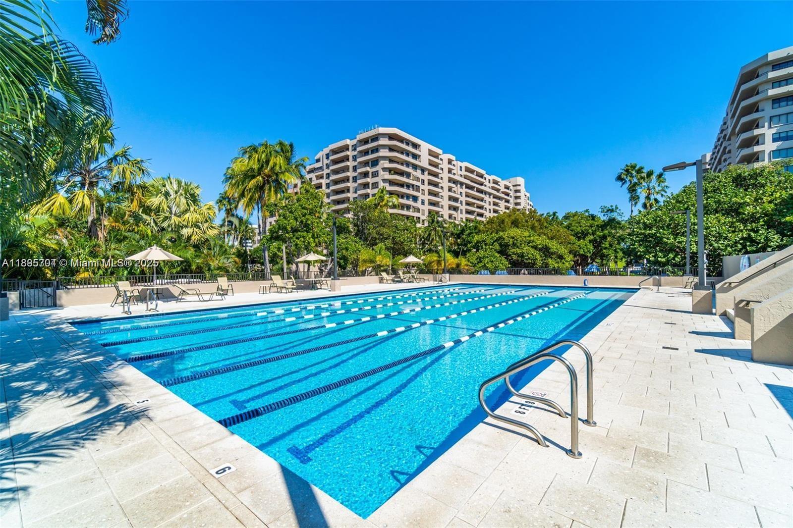 201 Crandon Boulevard, Unit 636 Key Biscayne, FL 33149 - Photo 34 of 53 a view of a swimming pool with a lounge chairs