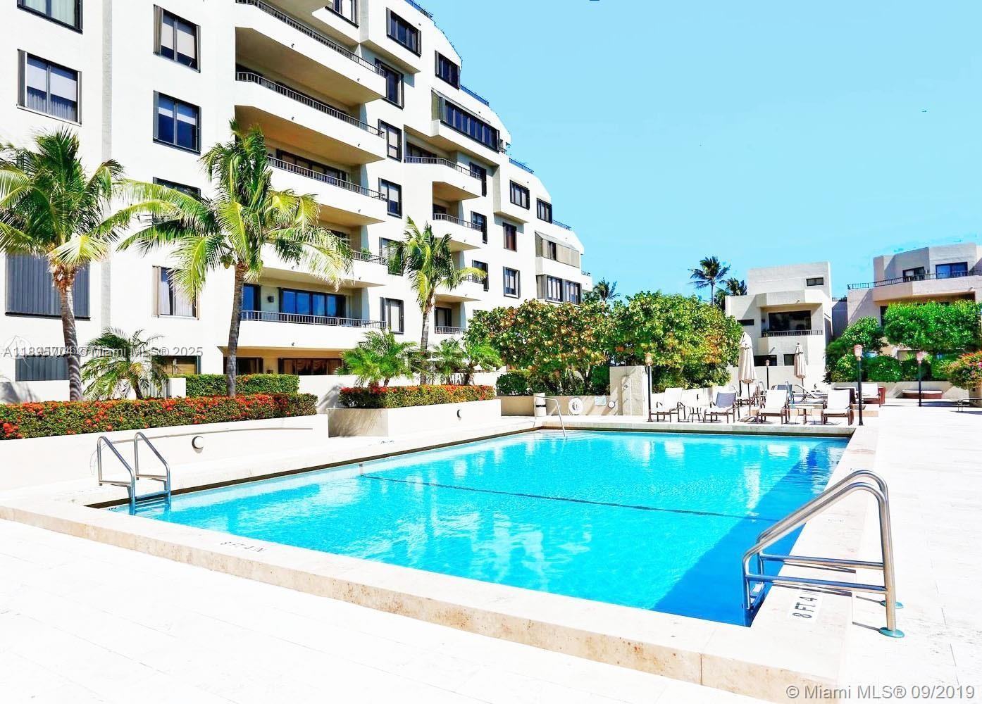 201 Crandon Boulevard, Unit 636 Key Biscayne, FL 33149 - Photo 35 of 53 a view of a swimming pool with outdoor seating