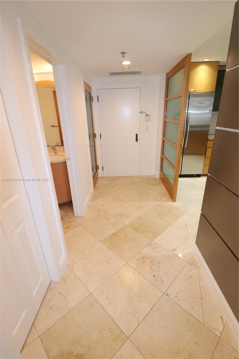 201 Crandon Boulevard, Unit 636 Key Biscayne, FL 33149 - Photo 4 of 53 a view of an empty room with wooden floor and a bathroom