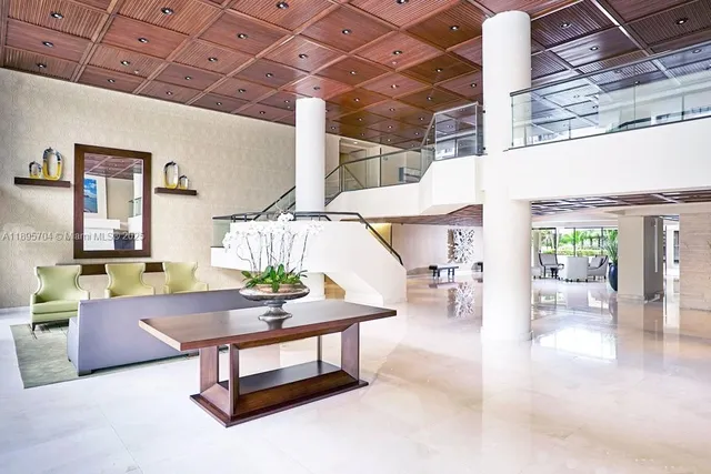 a lobby with furniture and floor to ceiling window