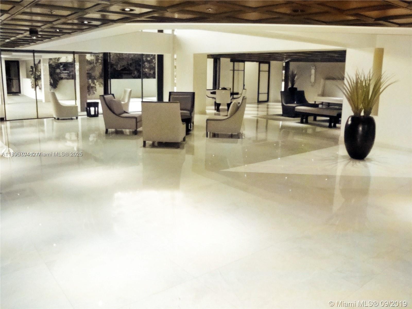 201 Crandon Boulevard, Unit 636 Key Biscayne, FL 33149 - Photo 47 of 53 a lobby with furniture and floor to ceiling window