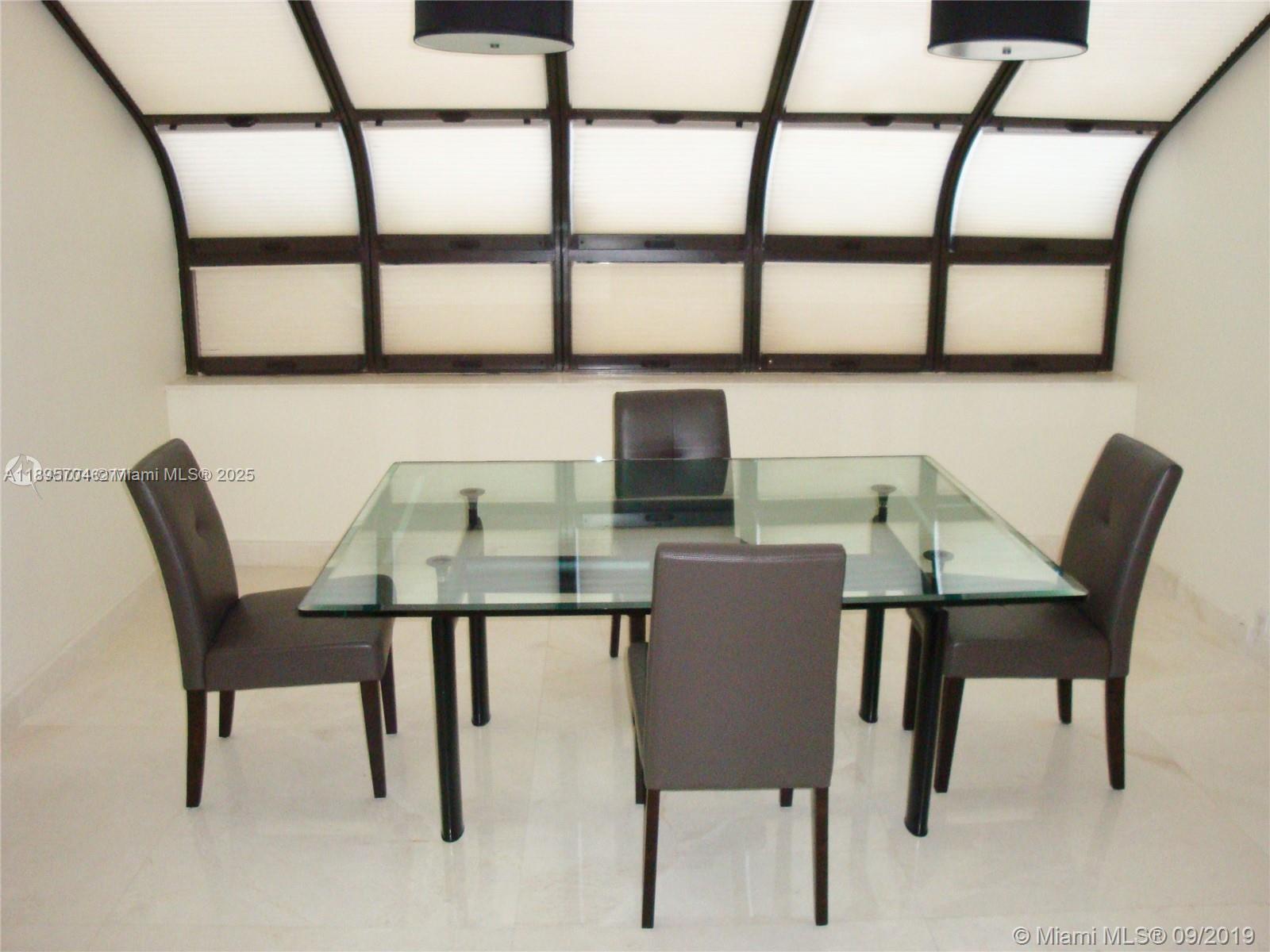 201 Crandon Boulevard, Unit 636 Key Biscayne, FL 33149 - Photo 49 of 53 a view of a dining room with furniture and window