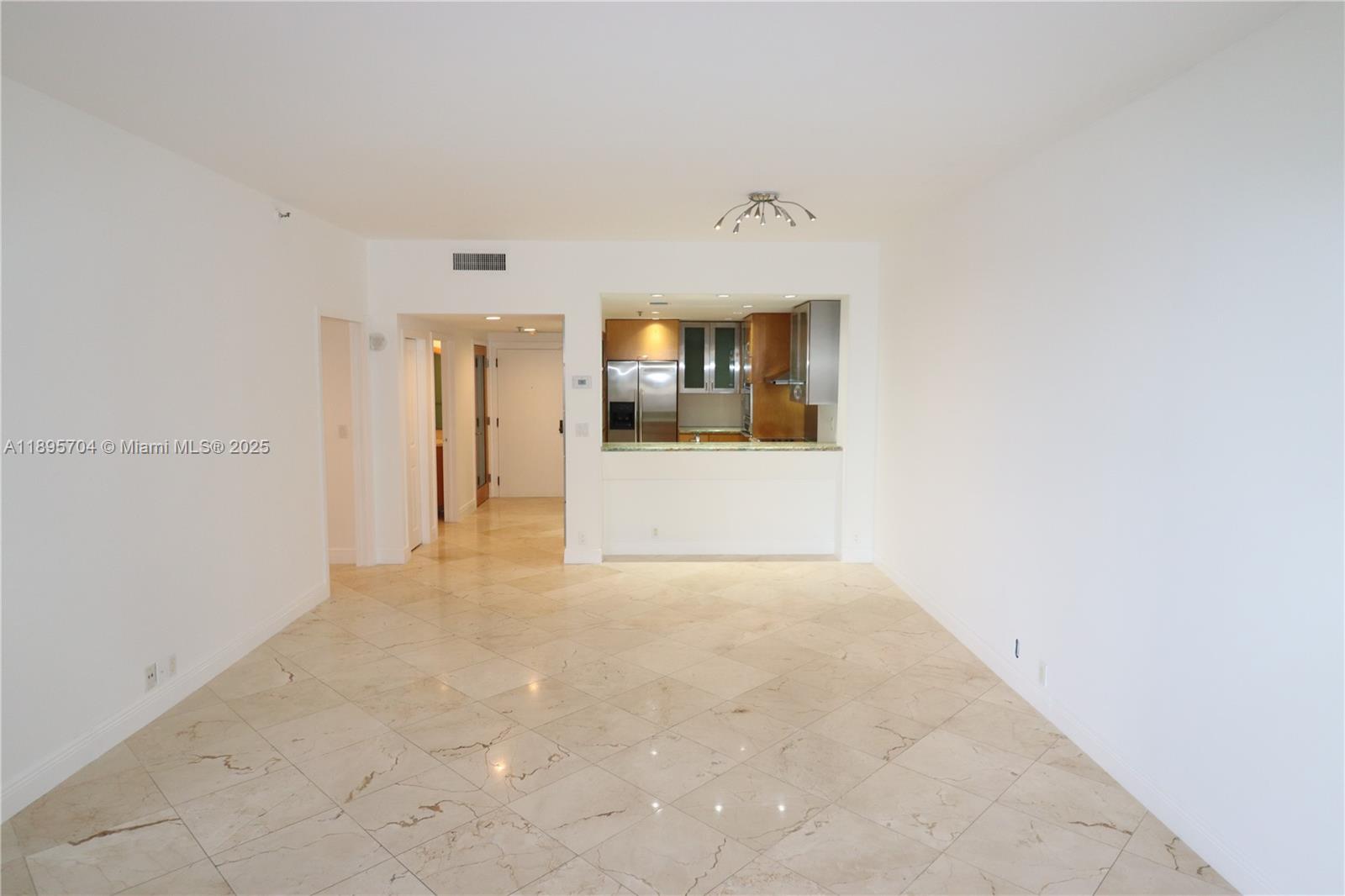 201 Crandon Boulevard, Unit 636 Key Biscayne, FL 33149 - Photo 6 of 53 a view of a big room with wooden cabinet and a refrigerator