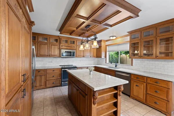 a view of an empty room with a fireplace and a window
