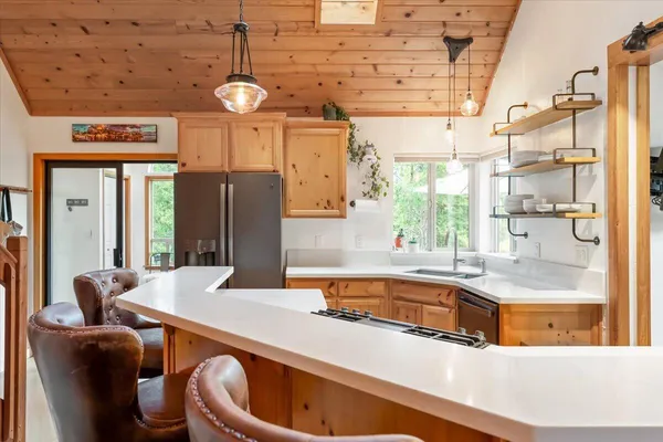 a dining table with chairs and window