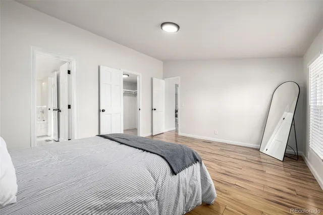 a bedroom with a bed and a large mirror