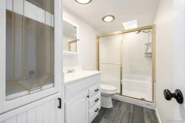 a bathroom with a double vanity sink toilet and shower