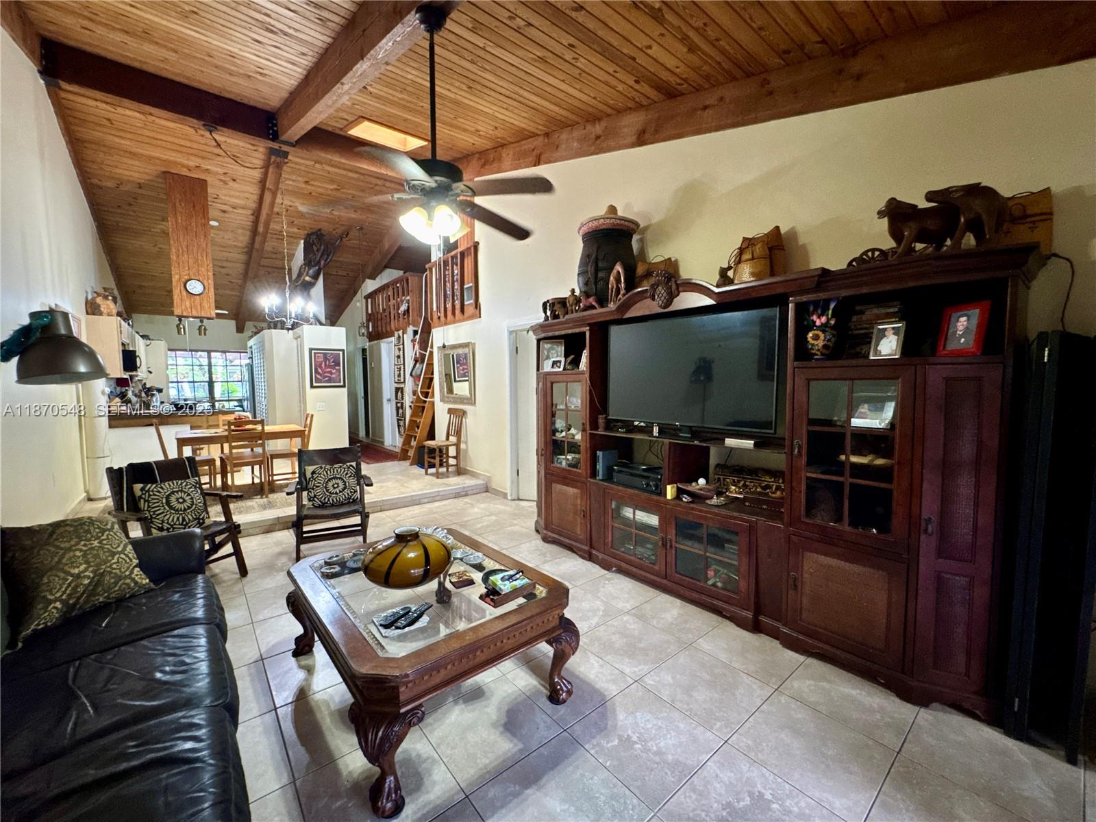 13527 Southwest 101st Lane Miami, FL 33186 - Photo 13 of 45 a living room with furniture and a flat screen tv