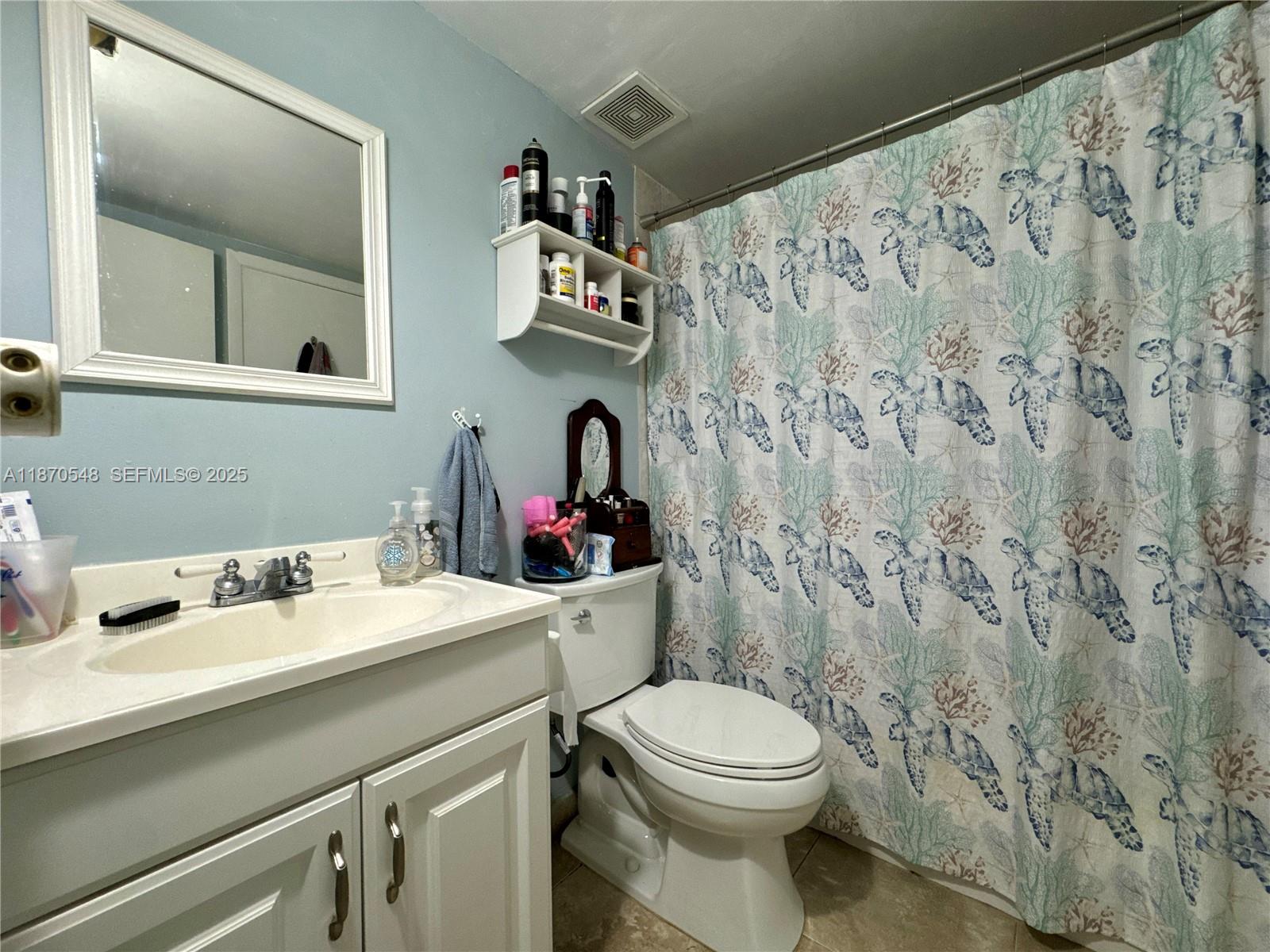 13527 Southwest 101st Lane Miami, FL 33186 - Photo 16 of 45 a bathroom with a sink and a mirror