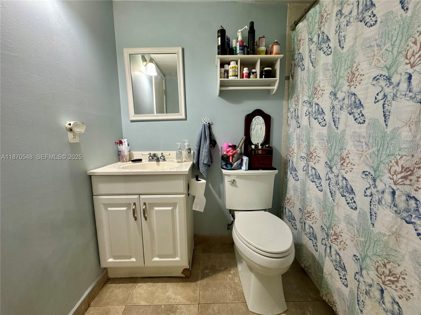 13527 Southwest 101st Lane Miami, FL 33186 - Photo 17 of 45 a bathroom with a toilet sink vanity and mirror