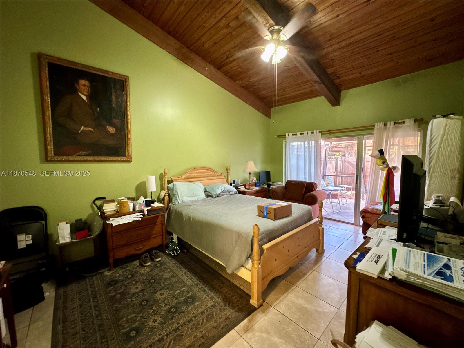 13527 Southwest 101st Lane Miami, FL 33186 - Photo 20 of 45 a bedroom with a bed and a flat screen tv