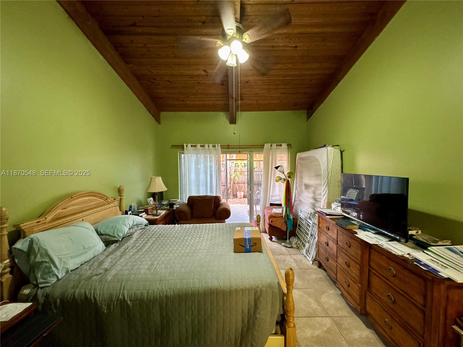 13527 Southwest 101st Lane Miami, FL 33186 - Photo 21 of 45 a bedroom with a bed and a chandelier
