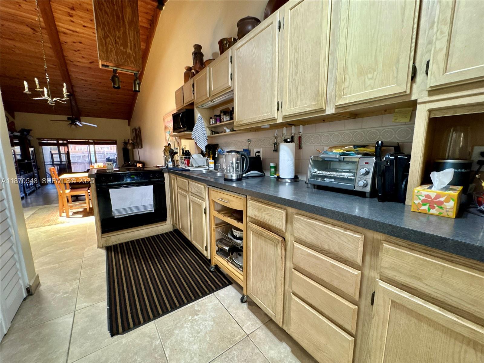 13527 Southwest 101st Lane Miami, FL 33186 - Photo 9 of 45 a kitchen with stainless steel appliances granite countertop a stove and cabinets