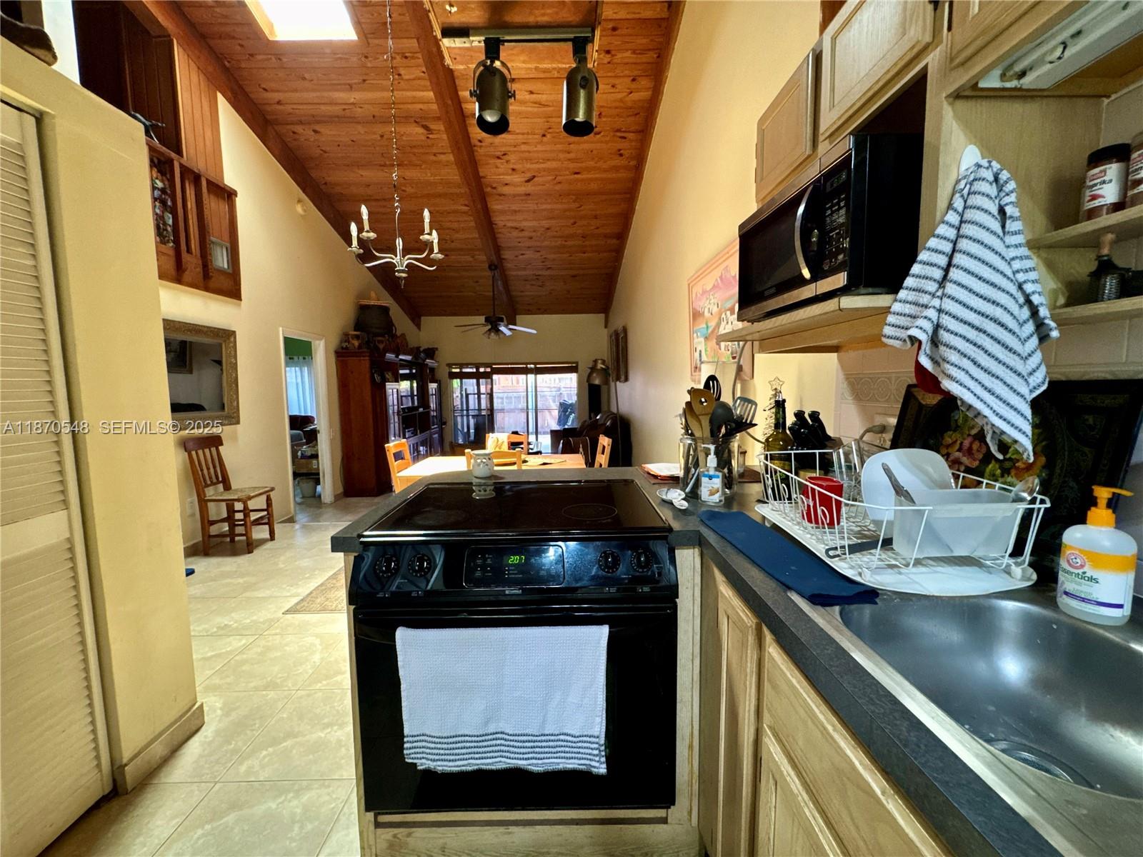 13527 Southwest 101st Lane Miami, FL 33186 - Photo 10 of 45 a kitchen with a sink a stove and cabinets