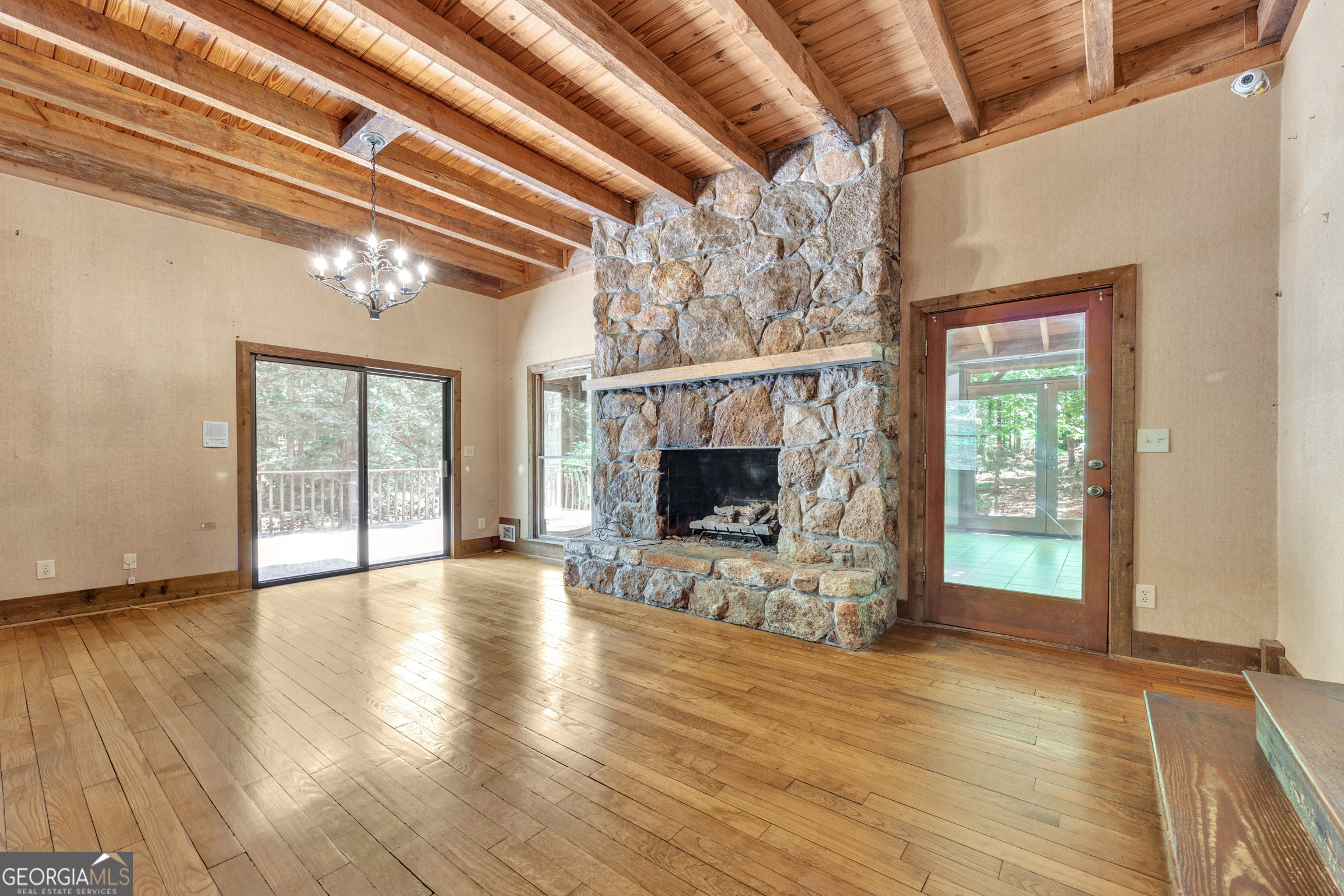 400 River Cove Road Social Circle, GA 30025 - Photo 17 of 83 a view of an empty room with wooden floor fireplace and a window