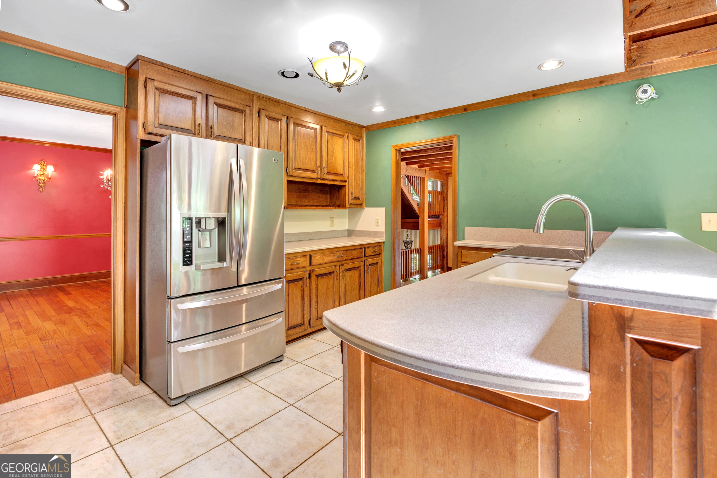 400 River Cove Road Social Circle, GA 30025 - Photo 23 of 83 a kitchen with kitchen island a stove a sink cabinetry and a refrigerator
