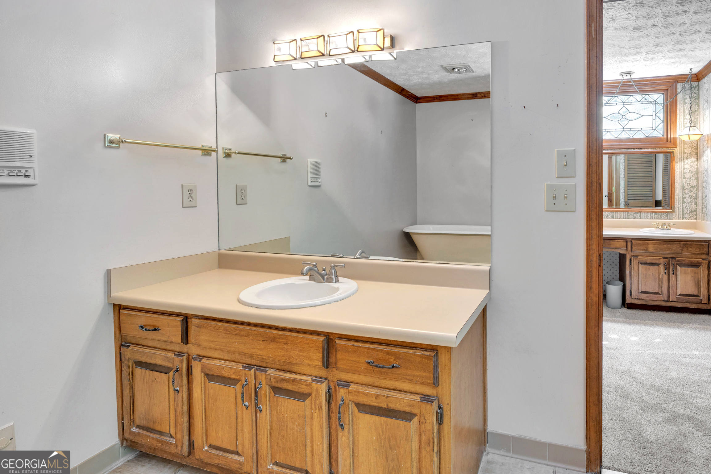 400 River Cove Road Social Circle, GA 30025 - Photo 42 of 83 a bathroom with a sink and a mirror