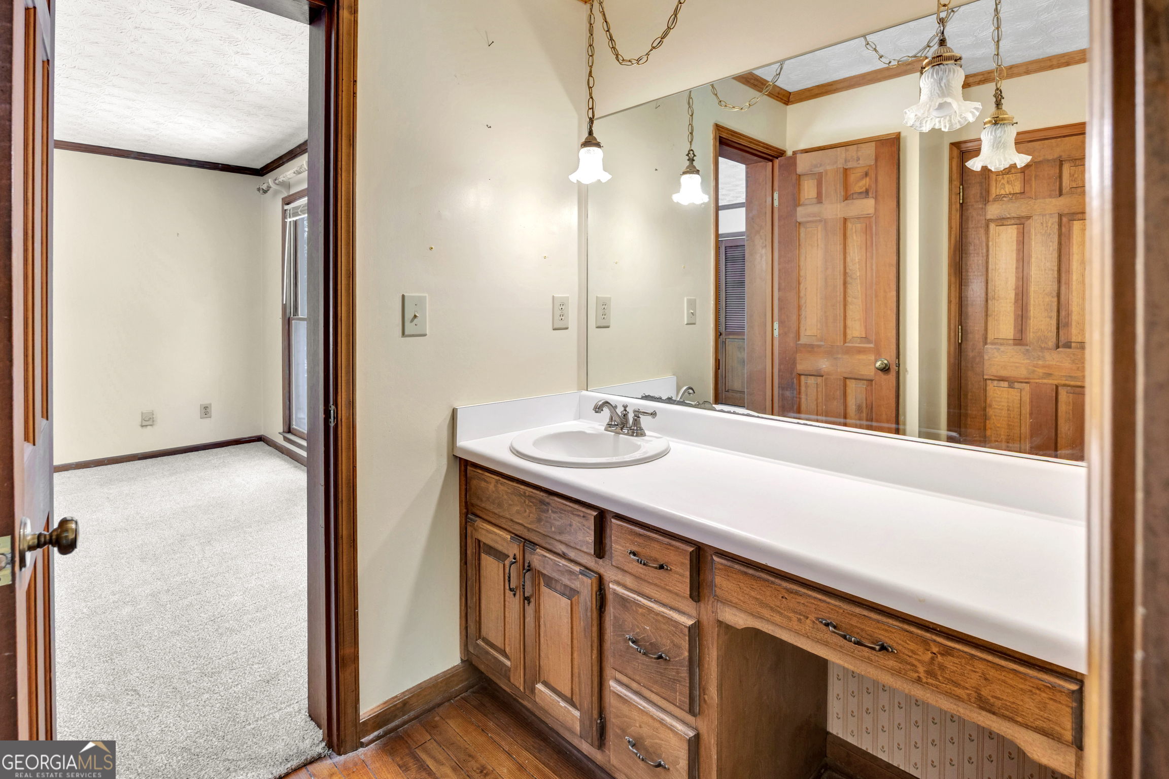 400 River Cove Road Social Circle, GA 30025 - Photo 47 of 83 a bathroom with a sink a mirror and a shower
