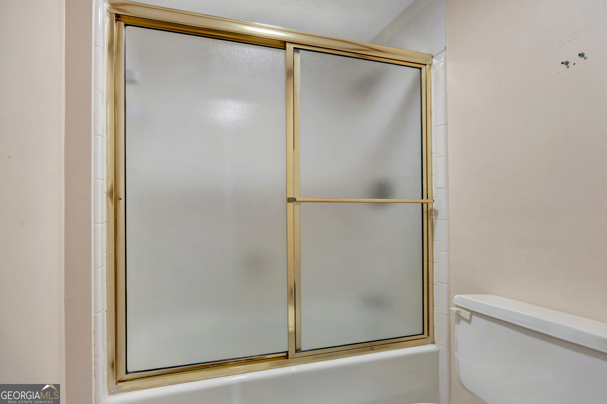400 River Cove Road Social Circle, GA 30025 - Photo 48 of 83 a bathroom with a glass shower door