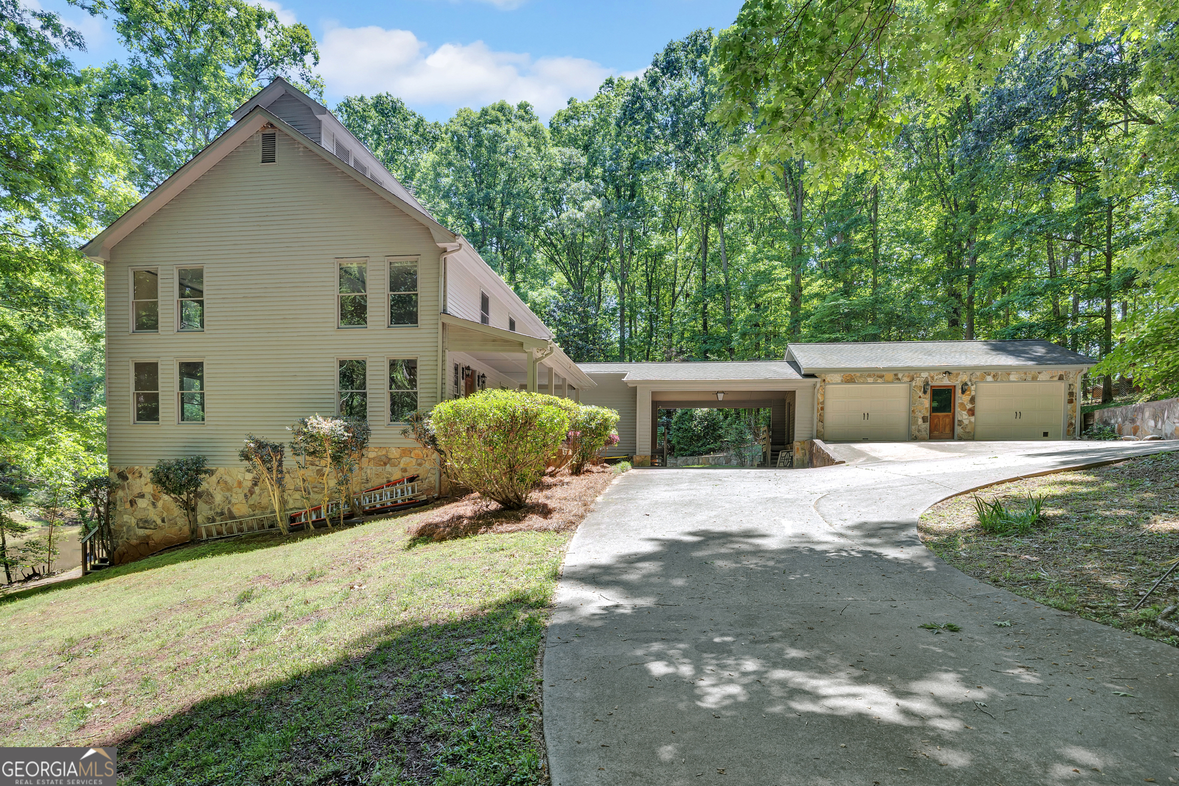 400 River Cove Road Social Circle, GA 30025 - Photo 5 of 83 a front view of a house with a yard and garage