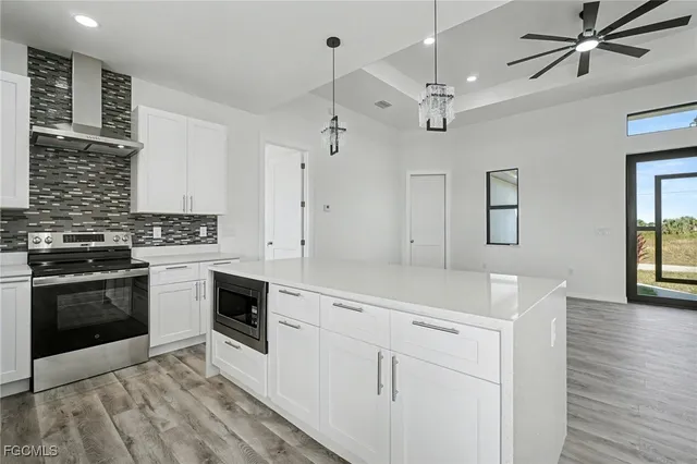 a kitchen with white cabinets and appliances