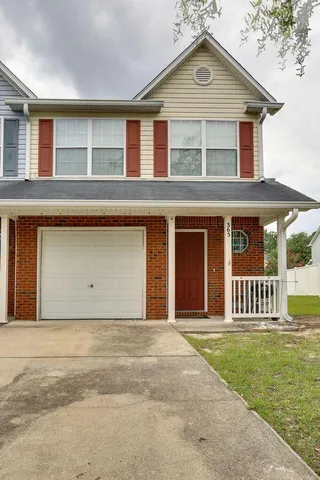 a front view of a house with garden