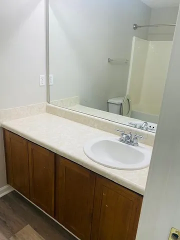 a white toilet sitting next to a bath tub and a sink