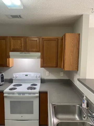 a kitchen with a stove and a microwave