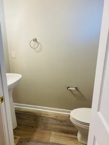 a white toilet sitting next to a shower