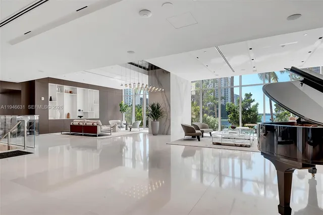 a living room with furniture a flat screen tv and a large window