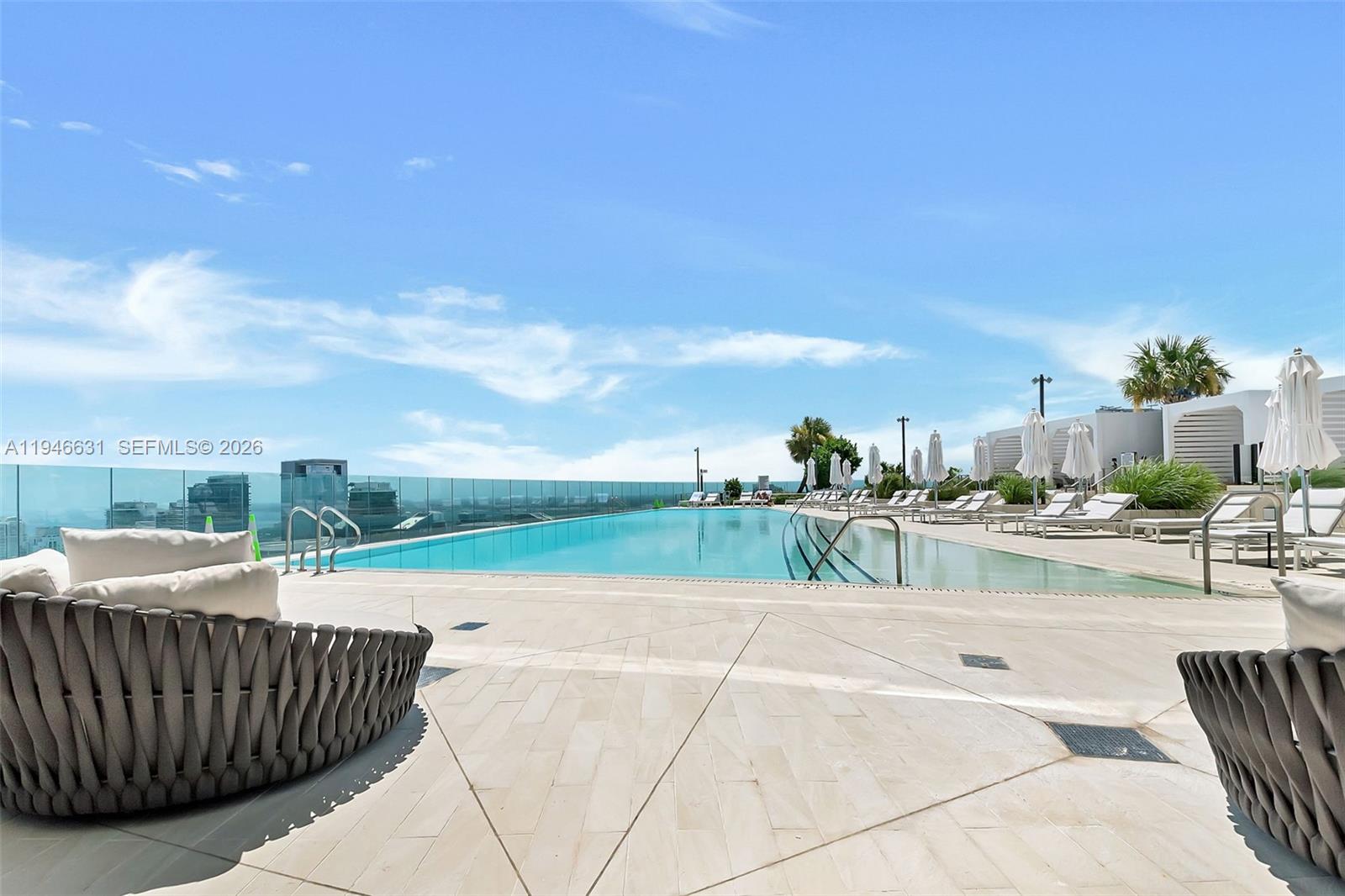 300 Biscayne Blvd Way, Unit 2808 Miami, FL 33131 - Photo 4 of 33 a view of swimming pool outdoor seating and kitchen in back