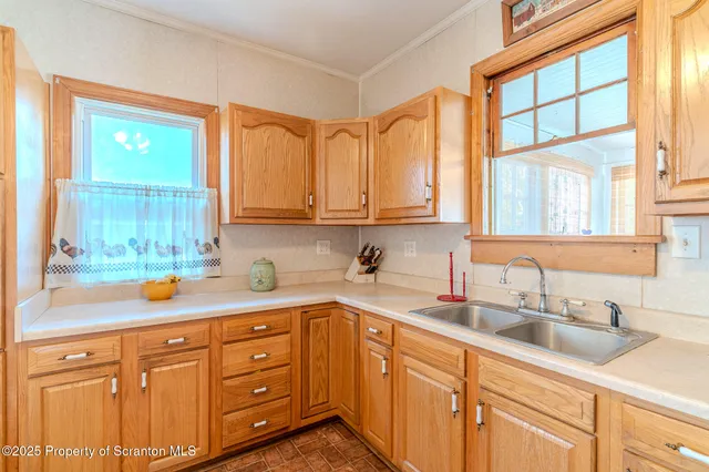 a kitchen with stainless steel appliances granite countertop a sink a stove and cabinets