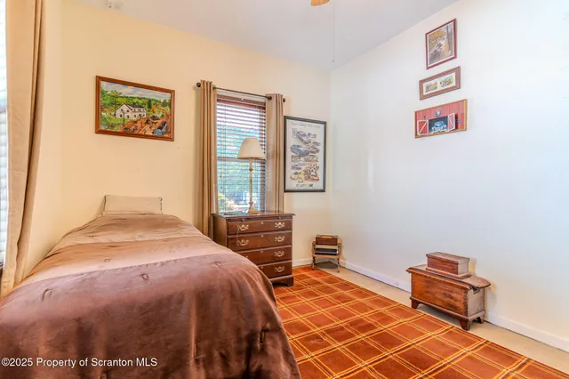 a bedroom with a bed and a table