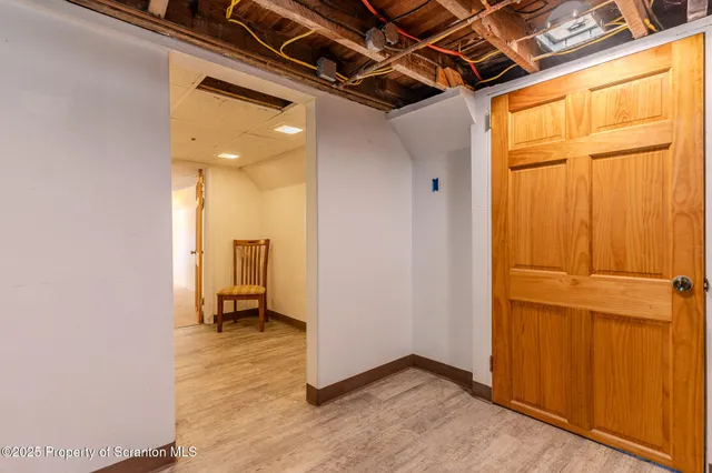 a view of a room with wooden floor