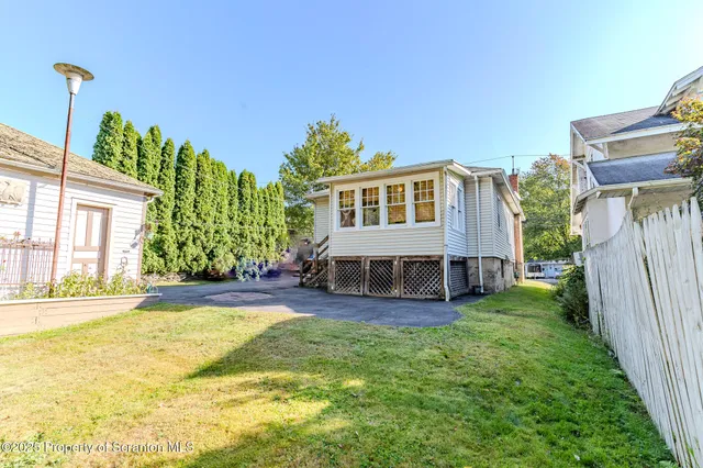 a view of a house with a yard and sitting area