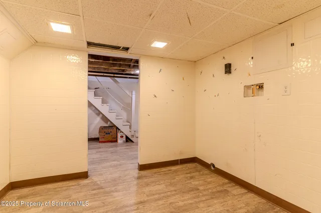 a view of an empty room with stairs and ventilation