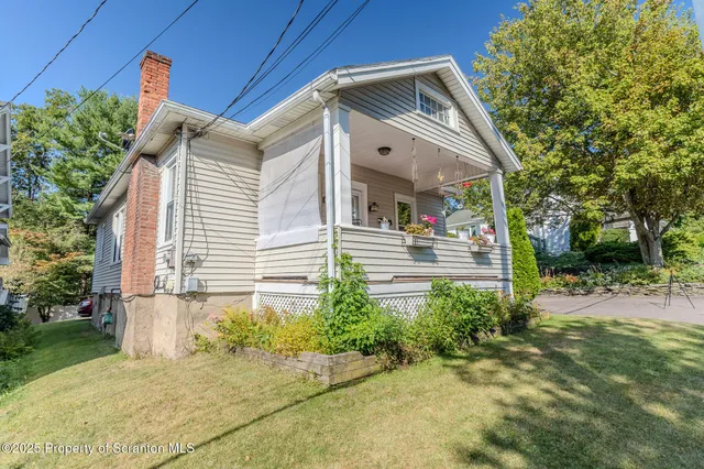 a view of a house with swimming pool and a yard