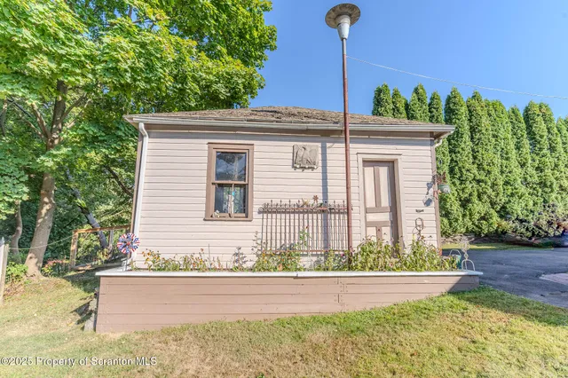 a view of a house with backyard and porch