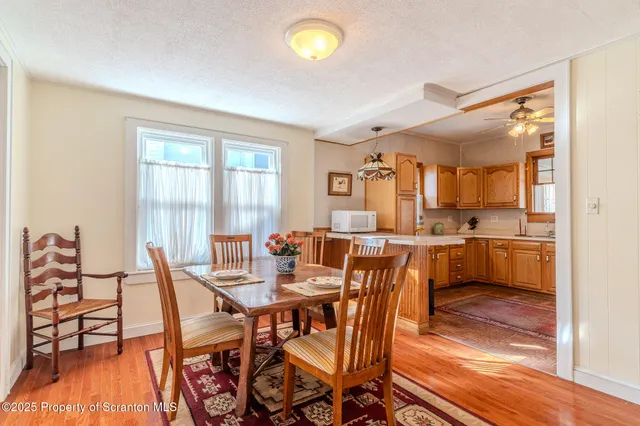 a view of a dining room with furniture and a wooden floor