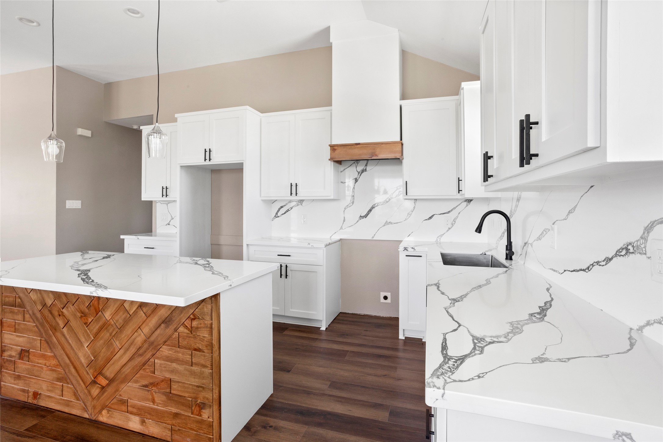 1226 9th Street San Leon, TX 77539 - Photo 12 of 32 a kitchen with a sink a kitchen island with stainless steel appliances