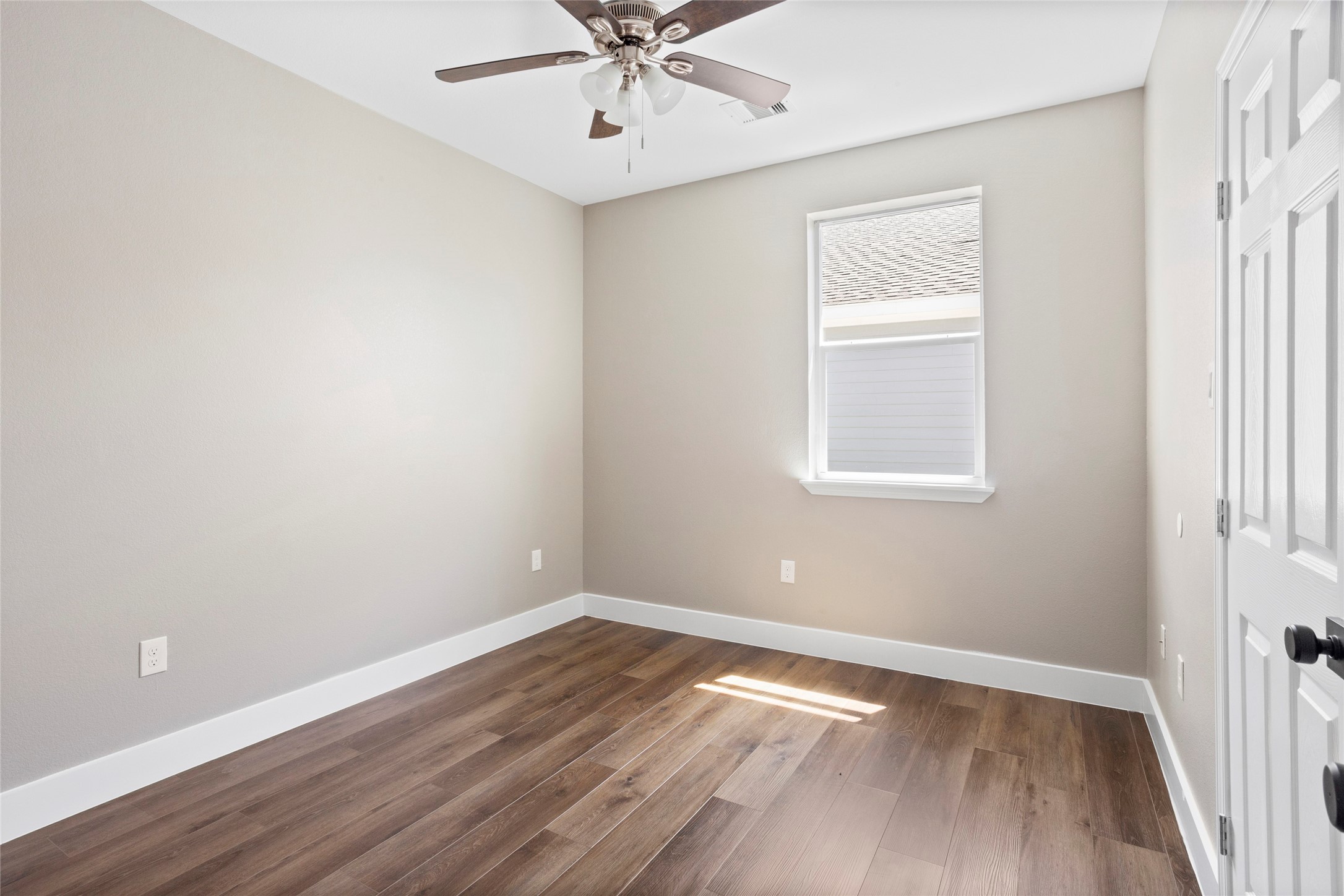 1226 9th Street San Leon, TX 77539 - Photo 21 of 32 an empty room with wooden floor chandelier fan and windows