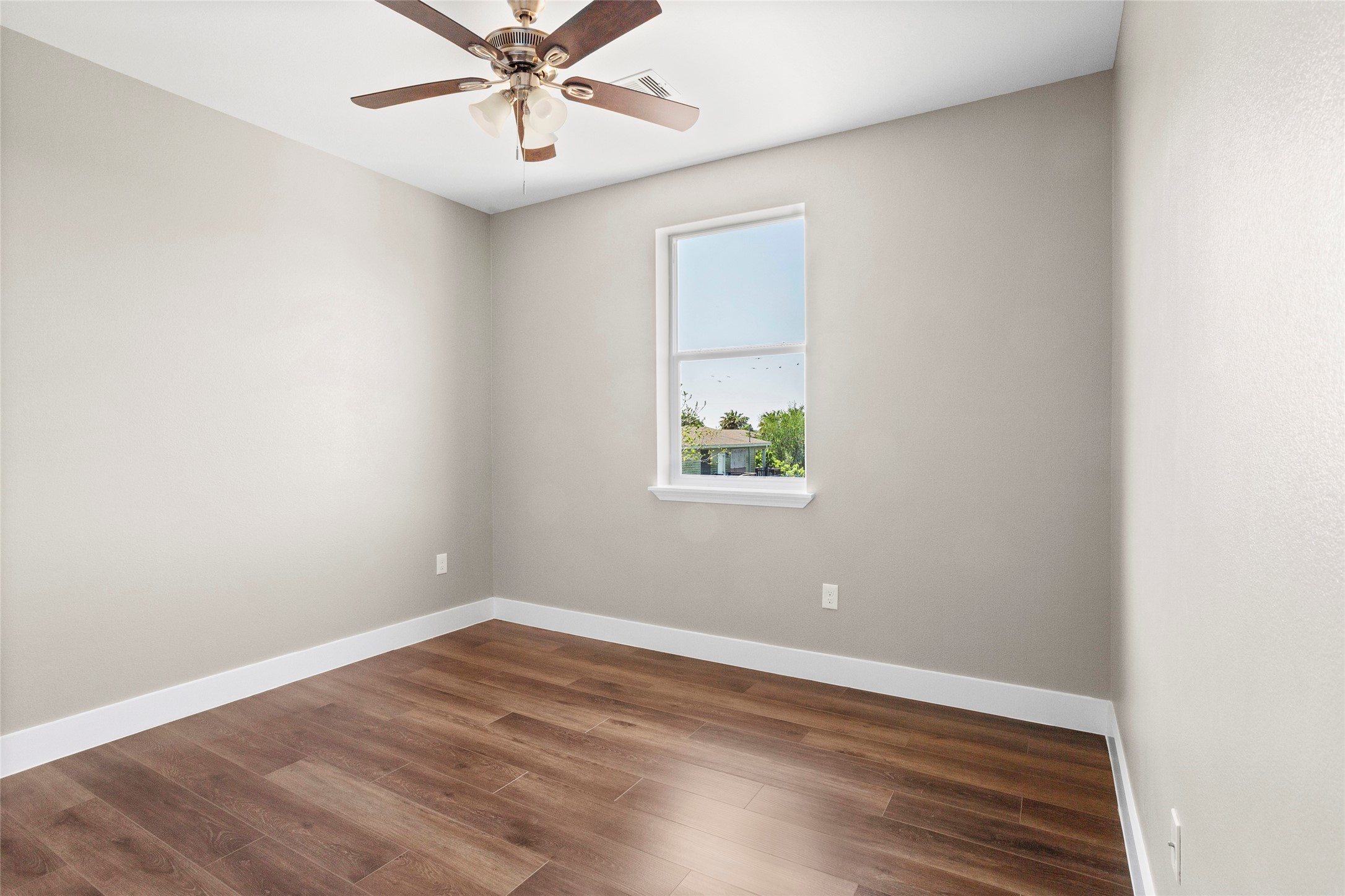 1226 9th Street San Leon, TX 77539 - Photo 23 of 32 an empty room with a window and a ceiling fan